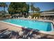 Community pool with lounge chairs at 1799 N Highland Ave # 38, Clearwater, FL 33755