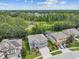 Two-story house with a grey exterior, two-car garage, and landscaped yard at 19322 Autumn Chase Ct, Land O Lakes, FL 34638