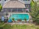 Aerial view of a home with a large screened-in pool and patio at 19322 Autumn Chase Ct, Land O Lakes, FL 34638