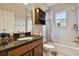 Clean bathroom with tub shower combo and dark wood vanity at 19322 Autumn Chase Ct, Land O Lakes, FL 34638