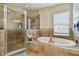 Bathroom features a large soaking tub and walk-in shower at 19322 Autumn Chase Ct, Land O Lakes, FL 34638