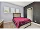 Bedroom with a queen bed and a chalkboard accent wall at 19322 Autumn Chase Ct, Land O Lakes, FL 34638