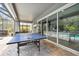 Outdoor game room with ping pong table and adjacent pool access at 19322 Autumn Chase Ct, Land O Lakes, FL 34638