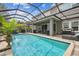 Resort-style backyard with a large pool, patio, and outdoor kitchen at 19322 Autumn Chase Ct, Land O Lakes, FL 34638