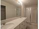 Bathroom with double vanity, large mirror, and walk-in shower at 19639 Shady Oak Dr, Land O Lakes, FL 34638