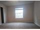 Bright bedroom with carpeted floor and a large window at 19639 Shady Oak Dr, Land O Lakes, FL 34638