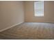 Simple bedroom with grey carpet and window with blinds at 19639 Shady Oak Dr, Land O Lakes, FL 34638