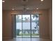 Living room with sliding glass doors and view of backyard at 19639 Shady Oak Dr, Land O Lakes, FL 34638