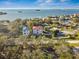 Aerial view of waterfront home with bay and bridge views at 1964 Cedar Dr, Dunedin, FL 34698