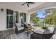 Relaxing covered patio with seating area and view of backyard at 1964 Cedar Dr, Dunedin, FL 34698