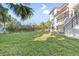 Spacious backyard with lush grass and home view at 1964 Cedar Dr, Dunedin, FL 34698