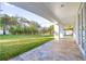 Covered patio overlooks a lush green backyard at 1964 Cedar Dr, Dunedin, FL 34698