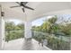 Covered balcony with arched entryway and outdoor fan at 1964 Cedar Dr, Dunedin, FL 34698