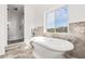 Elegant bathroom with freestanding tub, walk-in shower, and modern fixtures at 1964 Cedar Dr, Dunedin, FL 34698