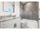 Modern bathroom with granite countertop and bathtub at 1964 Cedar Dr, Dunedin, FL 34698