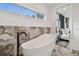 Spa-like bathroom with freestanding tub and modern fixtures at 1964 Cedar Dr, Dunedin, FL 34698