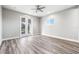 Spacious bedroom with hardwood floors and French doors at 1964 Cedar Dr, Dunedin, FL 34698