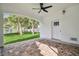 Covered patio with backyard view and ceiling fan at 1964 Cedar Dr, Dunedin, FL 34698