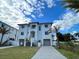 Modern two-story home with attached garage and driveway at 1964 Cedar Dr, Dunedin, FL 34698