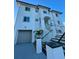 Modern white two story home with glass railings and stairs at 1964 Cedar Dr, Dunedin, FL 34698