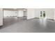 Large garage with grey epoxy flooring and multiple access points at 1964 Cedar Dr, Dunedin, FL 34698