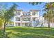 Luxury waterfront home with three stories and a beautiful lawn at 1964 Cedar Dr, Dunedin, FL 34698