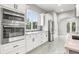 Modern kitchen with stainless steel appliances and white cabinets at 1964 Cedar Dr, Dunedin, FL 34698