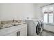 Laundry room with washer, dryer, and granite countertop at 1964 Cedar Dr, Dunedin, FL 34698