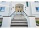 Modern staircase leading to the entrance of a waterfront home at 1964 Cedar Dr, Dunedin, FL 34698