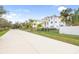 View down a residential street, showing a modern home at 1964 Cedar Dr, Dunedin, FL 34698