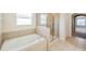 Bathroom features a shower and a garden tub at 20209 Merry Oak Ave, Tampa, FL 33647