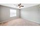 Well-lit bedroom, ceiling fan, and carpet flooring at 20209 Merry Oak Ave, Tampa, FL 33647