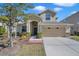 Two-story house with a tan exterior and two-car garage at 20209 Merry Oak Ave, Tampa, FL 33647