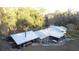 Aerial view of home with metal roof, carport and sprawling acreage surrounded by mature trees at 20490 Pinewood Dairy Rd, Brooksville, FL 34601