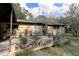 Exterior view of a house featuring wood deck with planters and backyard at 20490 Pinewood Dairy Rd, Brooksville, FL 34601