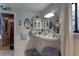 Bright blue bathroom with a walk-in closet and white vanity at 20490 Pinewood Dairy Rd, Brooksville, FL 34601