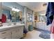 Bathroom featuring double sink vanity with bright lighting and ample counter space at 20490 Pinewood Dairy Rd, Brooksville, FL 34601