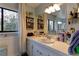 White bathroom with a single vanity and window at 20490 Pinewood Dairy Rd, Brooksville, FL 34601