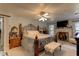 Main bedroom with king-size bed, fireplace, and ceiling fan at 20490 Pinewood Dairy Rd, Brooksville, FL 34601