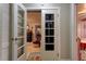 Bedroom featuring wood flooring, a dresser and entryway with glass paned doors at 20490 Pinewood Dairy Rd, Brooksville, FL 34601