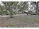 Long driveway leading to a ranch house in the woods at 20490 Pinewood Dairy Rd, Brooksville, FL 34601