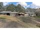 Back of house showcasing screened porch and carport at 20490 Pinewood Dairy Rd, Brooksville, FL 34601