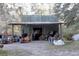 View of the exterior of a metal building with an open workshop area at 20490 Pinewood Dairy Rd, Brooksville, FL 34601