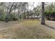 House nestled among tall trees on a large lot at 20490 Pinewood Dairy Rd, Brooksville, FL 34601