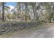 Rock retaining wall on a sprawling lot with mature trees at 20490 Pinewood Dairy Rd, Brooksville, FL 34601