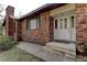 Brick front exterior with a white door and concrete steps at 20490 Pinewood Dairy Rd, Brooksville, FL 34601