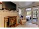 Living room featuring french doors, a fireplace and comfortable chair at 20490 Pinewood Dairy Rd, Brooksville, FL 34601