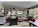 Enclosed patio featuring wicker furniture, ceiling fan, and views of the backyard at 20490 Pinewood Dairy Rd, Brooksville, FL 34601