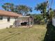 A view of the backyard patio with pergola and a grassy yard at 2134 Victory Ave, Largo, FL 33770