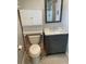 Bathroom with tiled floors, toilet, vanity with modern fixtures and storage at 2134 Victory Ave, Largo, FL 33770